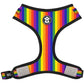 Rainbow striped dog harness with reflective material on a white background