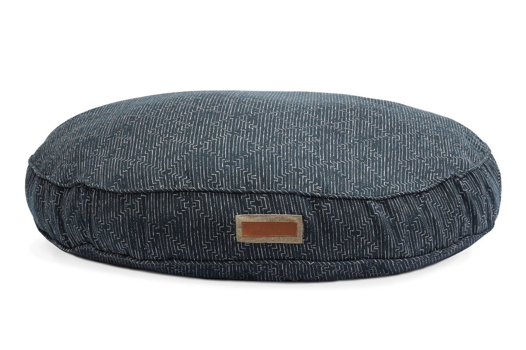 Round blue pet bed with a textured pattern on a white background