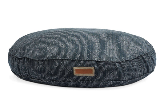 Round blue pet bed with a textured pattern on a white background