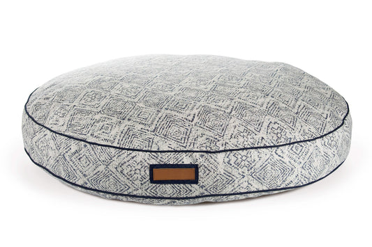 Round gray pet bed with a pattern and brown label on a white background