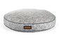 Round gray pet bed with a pattern and brown label on a white background