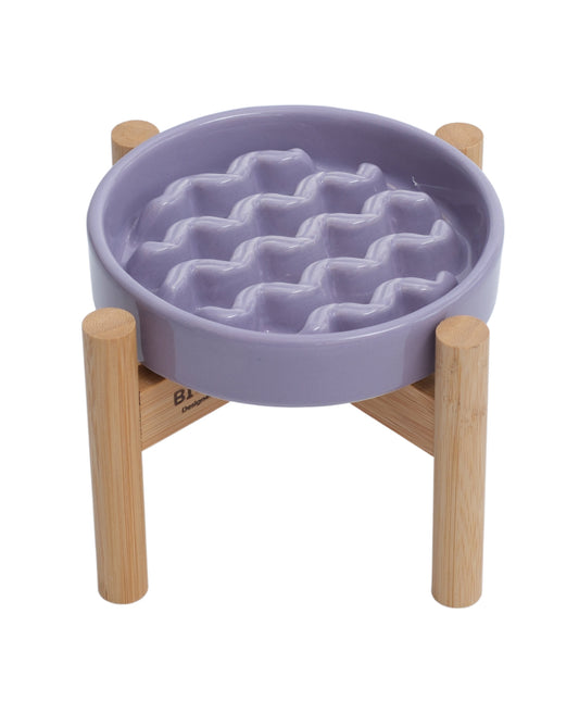 Purple pet bowl with wavy texture on a wooden stand against a white background
