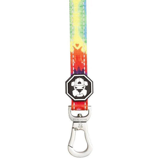 Colorful tie-dye dog leash with a black and white clip on a white background