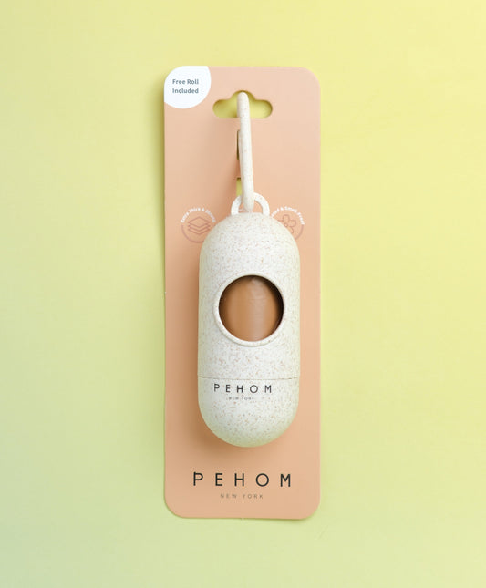 Pehom poop bag dispenser on a pink card with a yellow background
