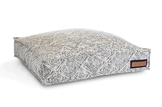 Patterned pet bed with a brand label on a white background