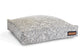 Patterned pet bed with a brand label on a white background
